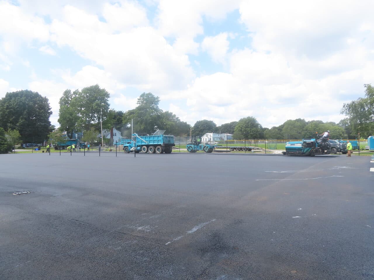 Commercial Parking Lot Paving project in Barrington, RI — wide finished lot with equipment