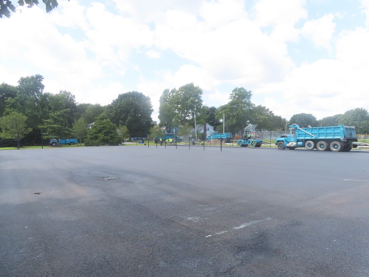 Commercial Parking Lot Paving project in Barrington, RI — finished lot trucks at edge
