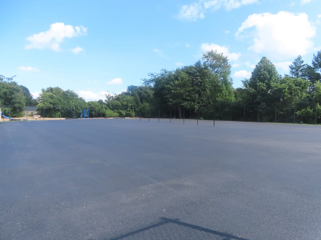Commercial Parking Lot Paving project in Barrington, RI — clean finished lot near playground