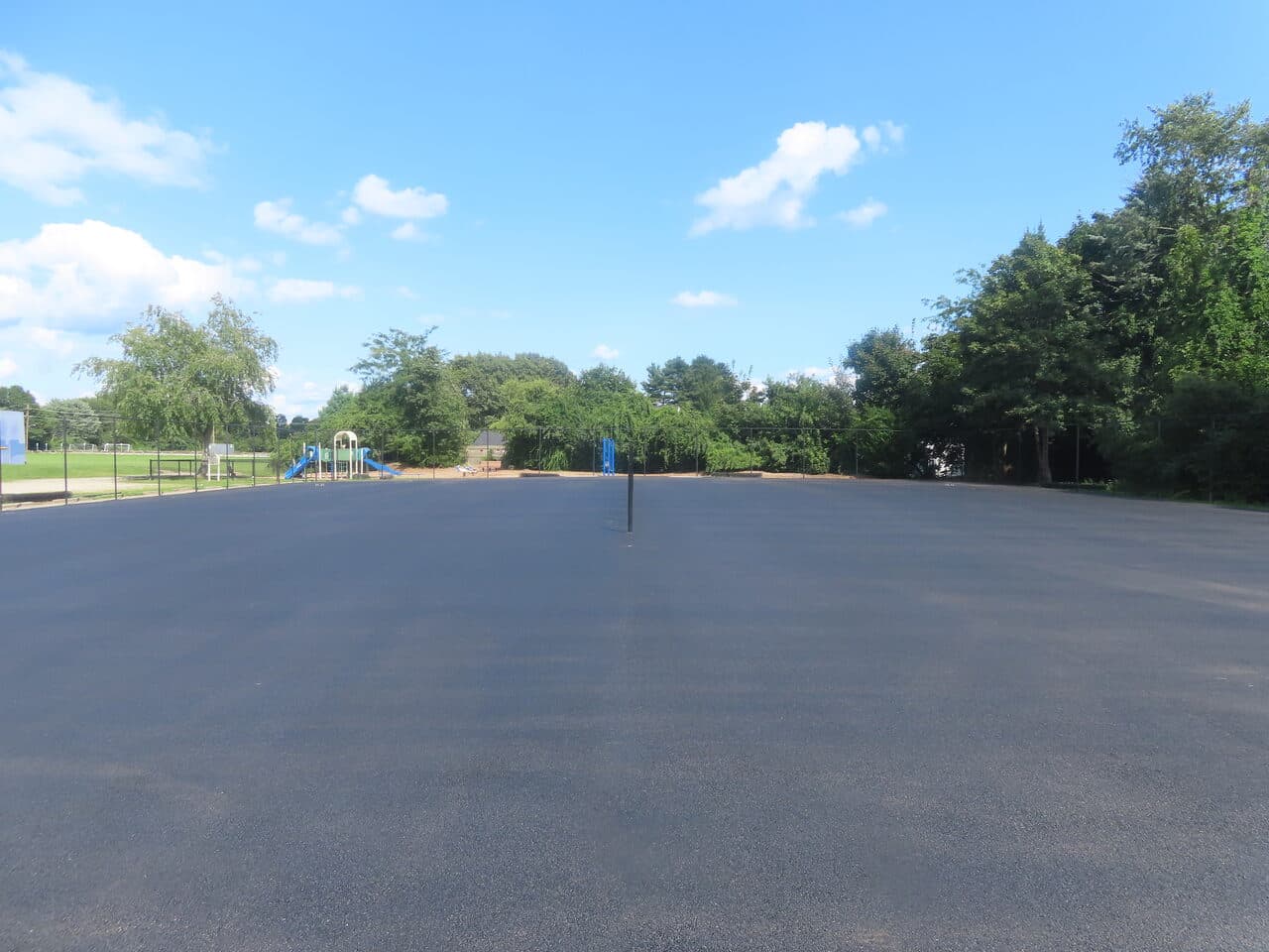 Commercial Parking Lot Paving project in Barrington, RI — finished lot wide playground view