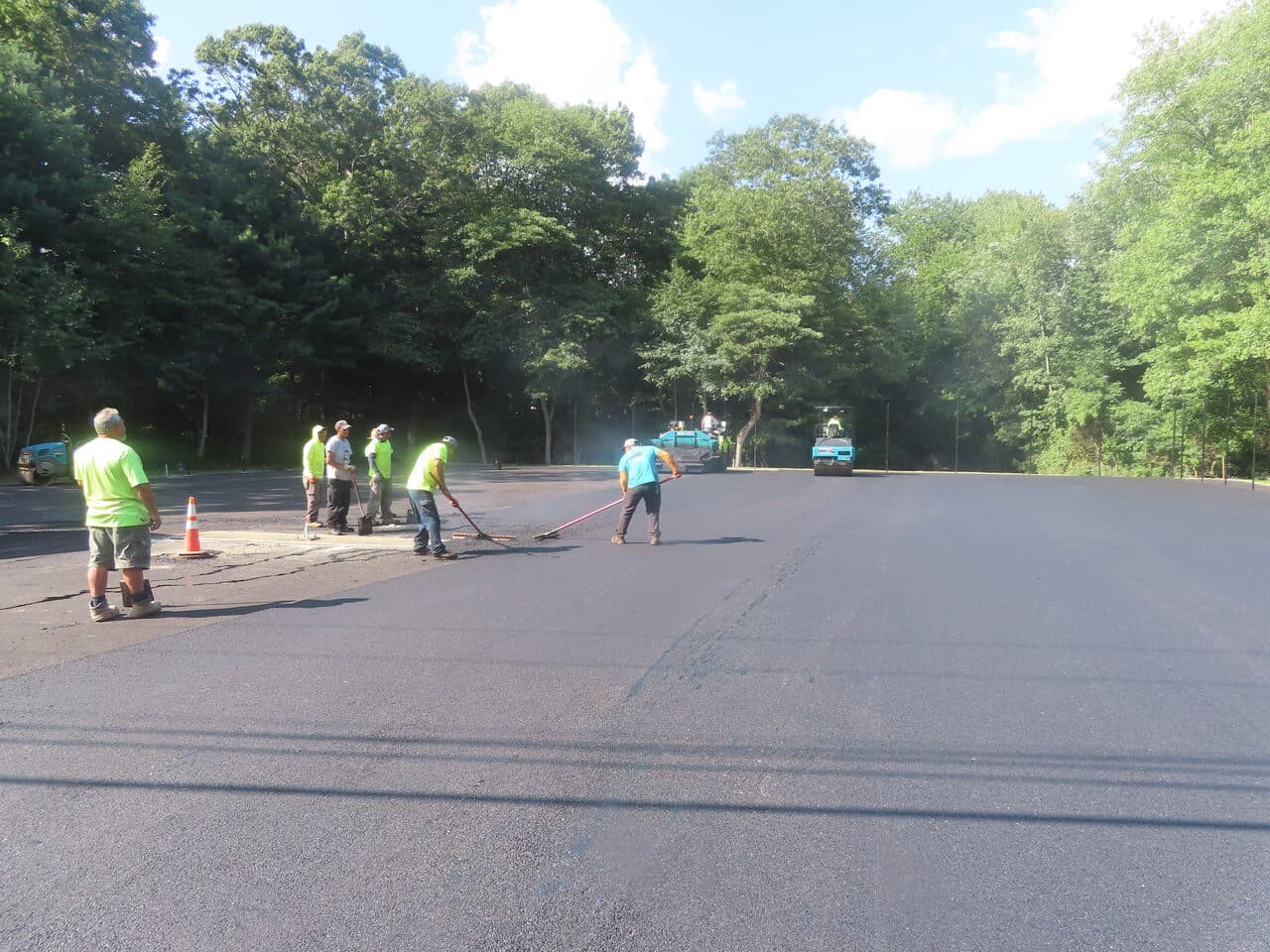 Commercial Parking Lot Paving project in Barrington, RI — crew raking on wide lot