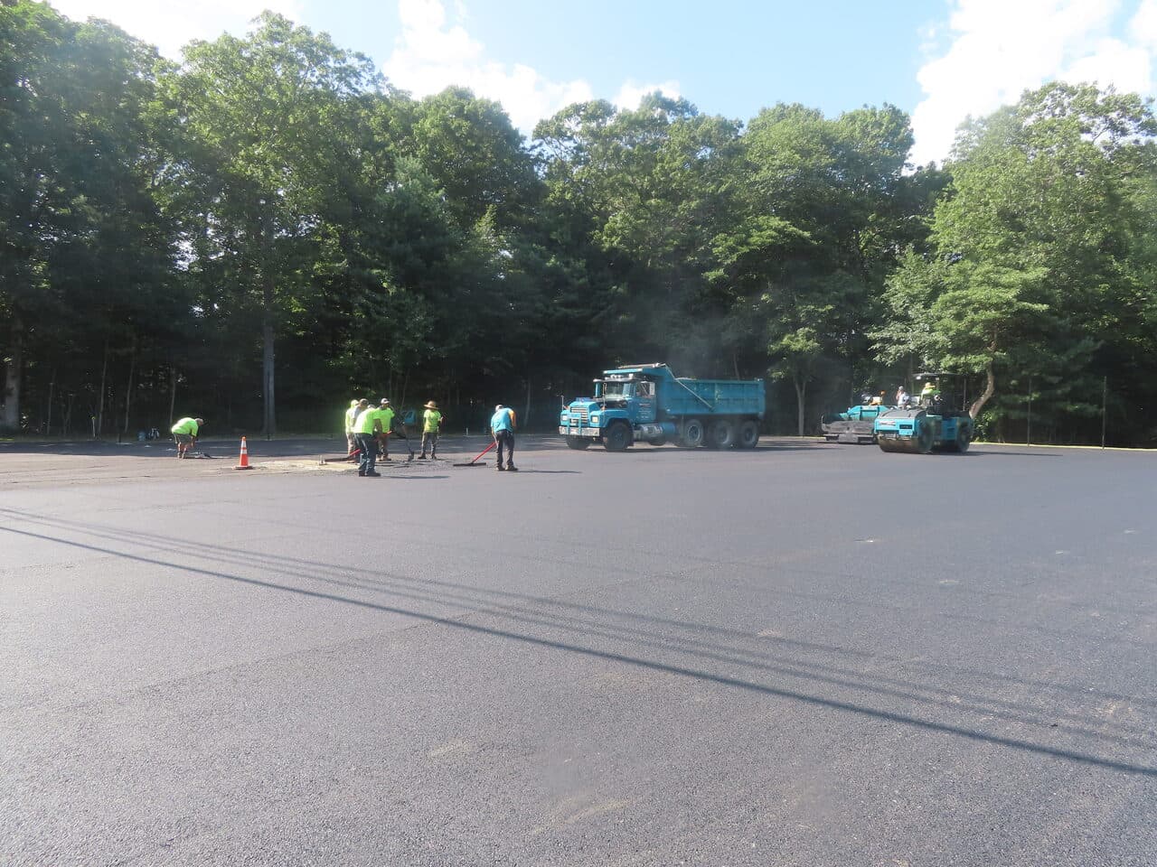 Commercial Parking Lot Paving project in Barrington, RI — wide lot dump truck and crew