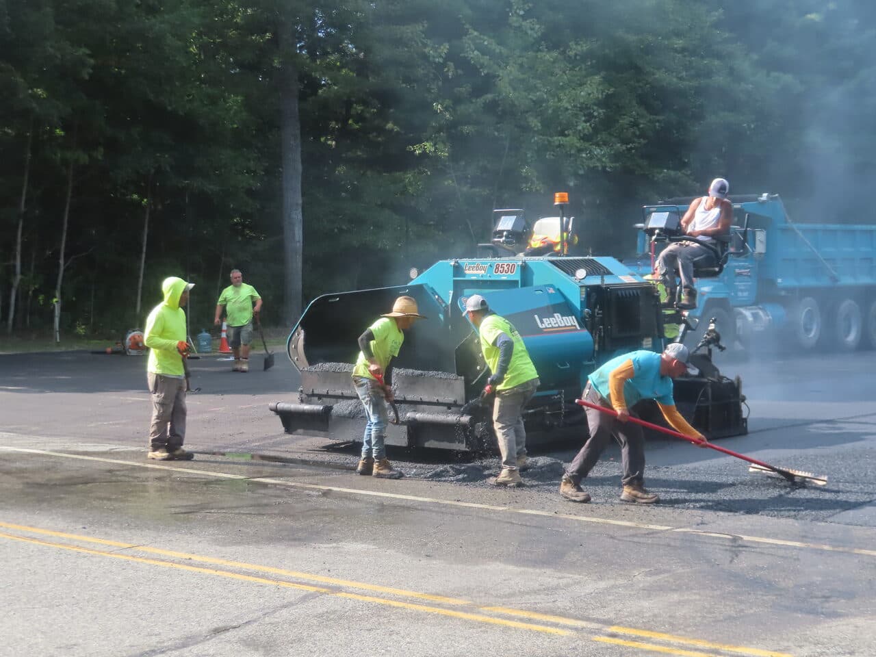 Commercial Parking Lot Paving project in Barrington, RI — crew at paver close action