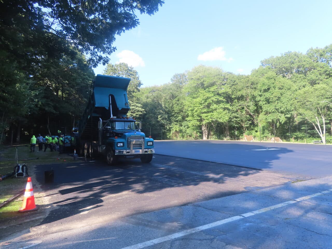 Commercial Parking Lot Paving project in Barrington, RI — dump truck bed raised at lot