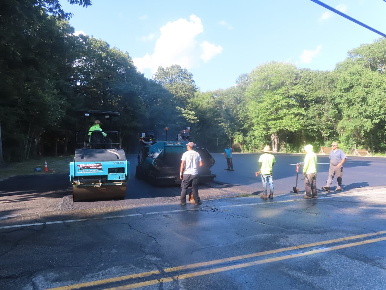 Commercial Parking Lot Paving project in Barrington, RI — roller and crew on roadway edge