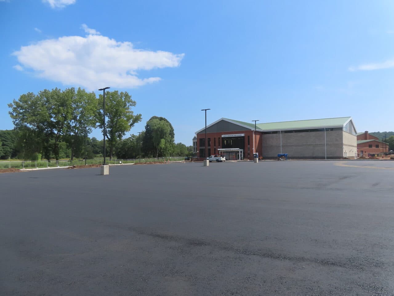 Commercial Parking Lot Paving project in North Branford, CT — finished lot with school in background
