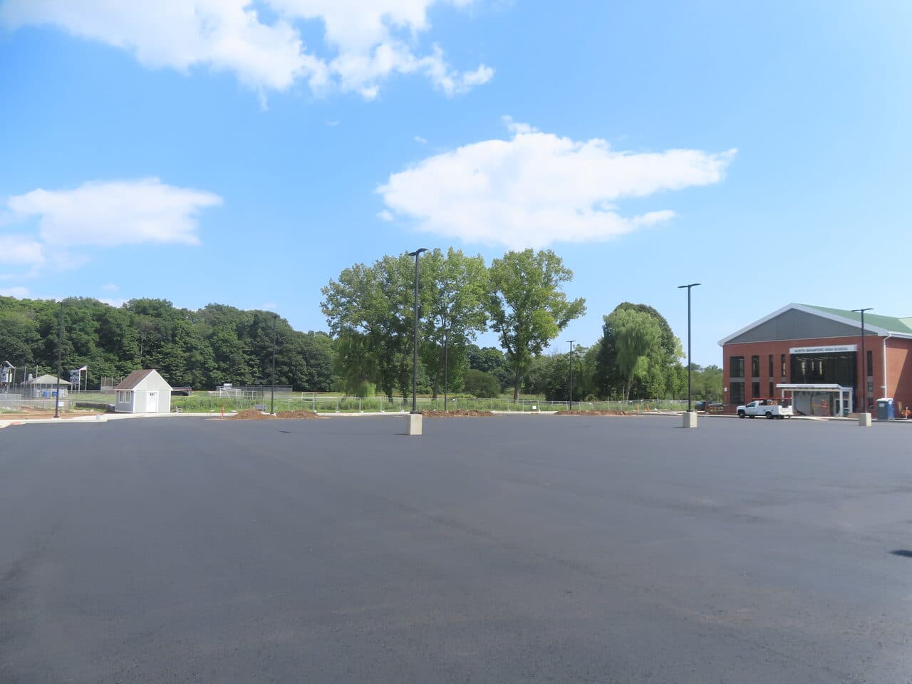 After — Commercial Parking Lot Paving in North Branford, CT (fresh paved lot with paving crew)