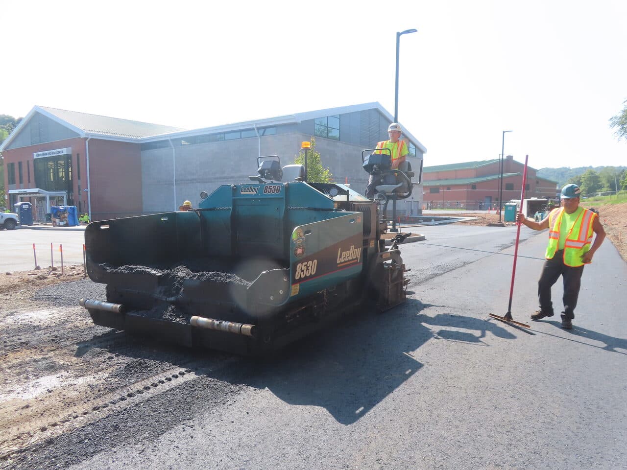 Commercial Parking Lot Paving project in North Branford, CT — LeeBoy paver with crew raking