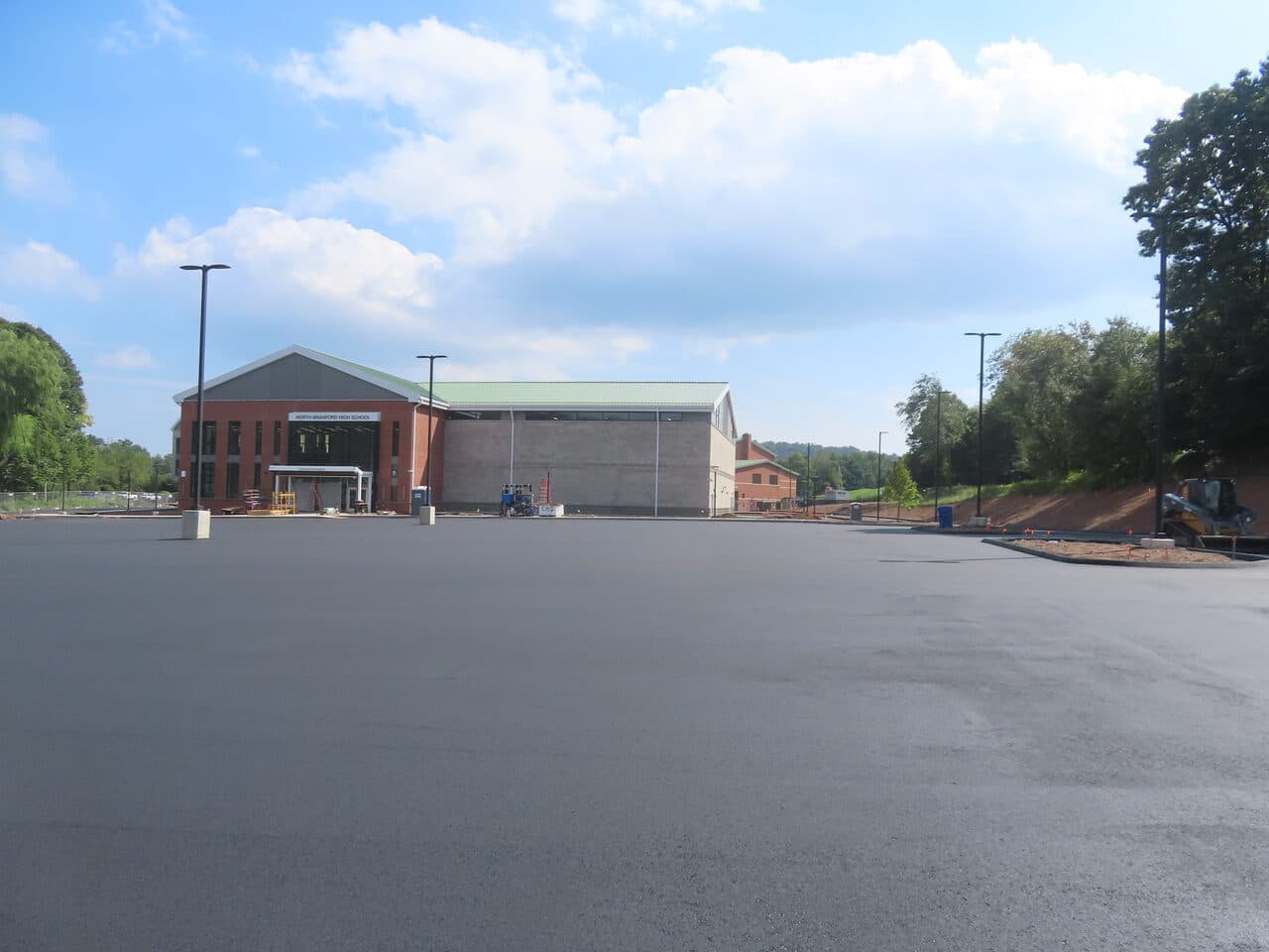 Commercial Parking Lot Paving project in North Branford, CT — finished asphalt lot with school building