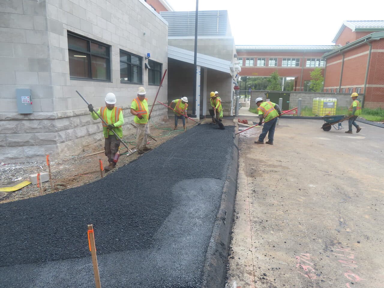 Commercial Parking Lot Paving project in North Branford, CT — crew paving walkway by hand