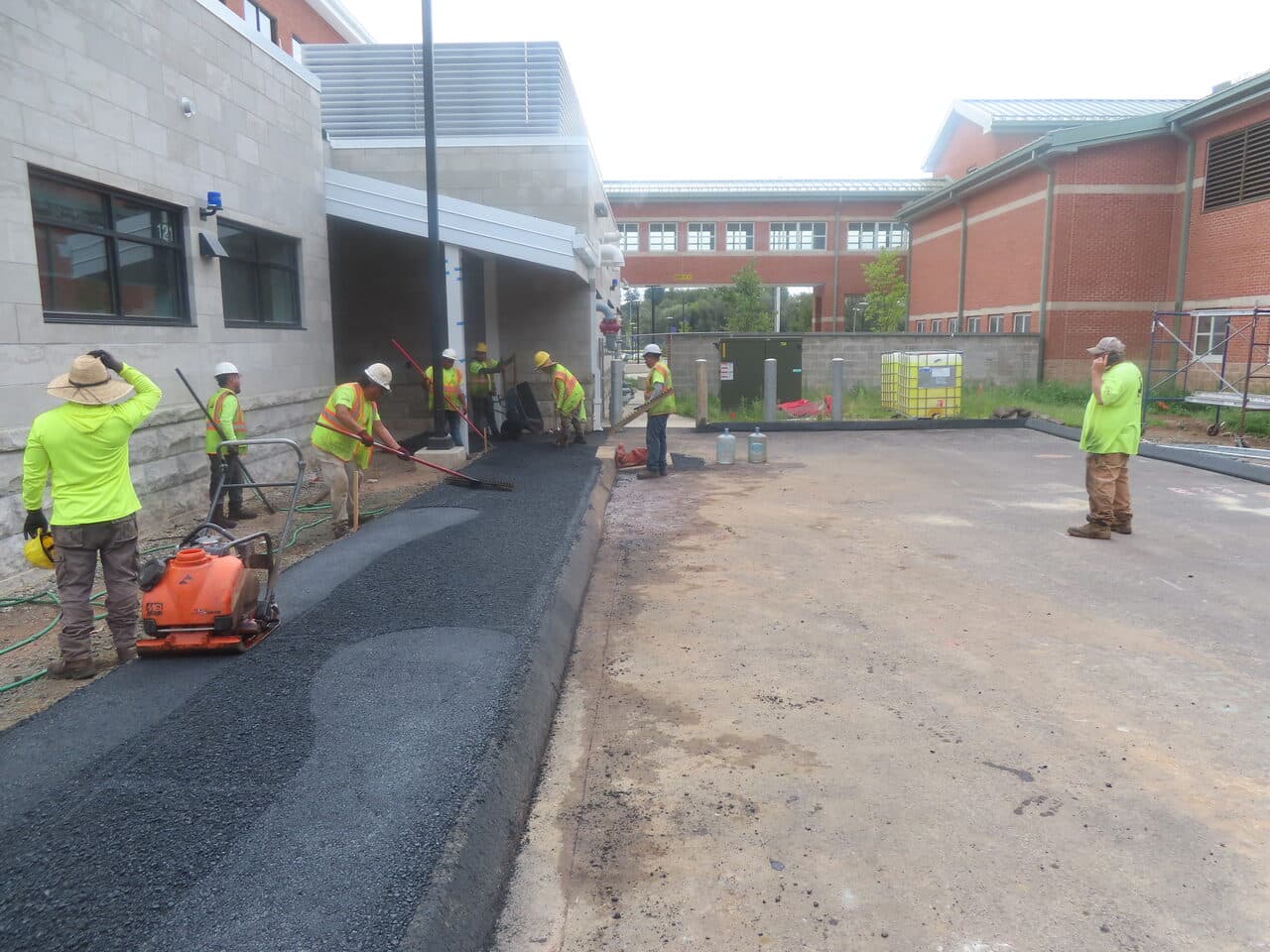 Commercial Parking Lot Paving project in North Branford, CT — crew compacting new walkway asphalt