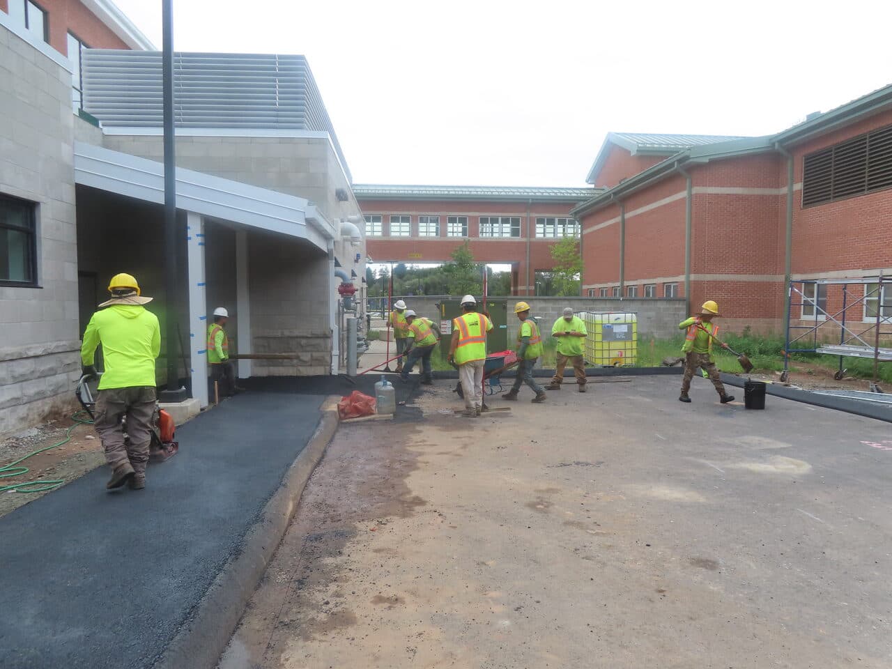 Commercial Parking Lot Paving project in North Branford, CT — crew raking new walkway asphalt