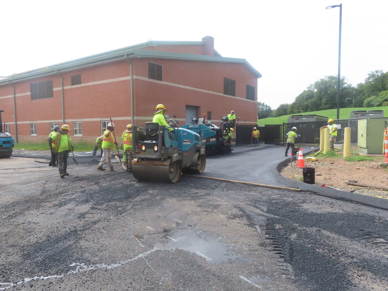 Commercial Parking Lot Paving project in North Branford, CT — roller and crew paving driveway