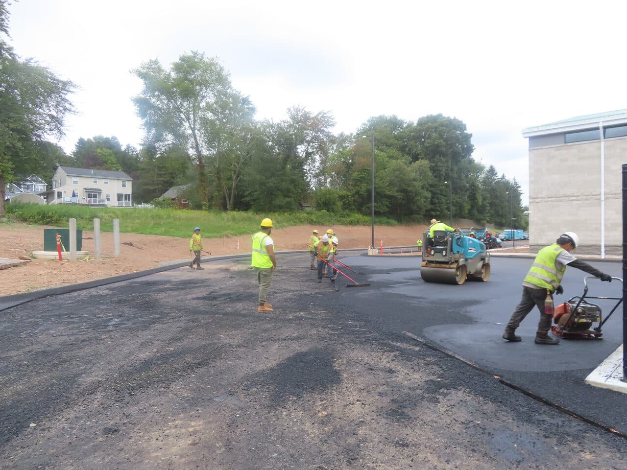 Commercial Parking Lot Paving project in North Branford, CT — crew and roller paving access road