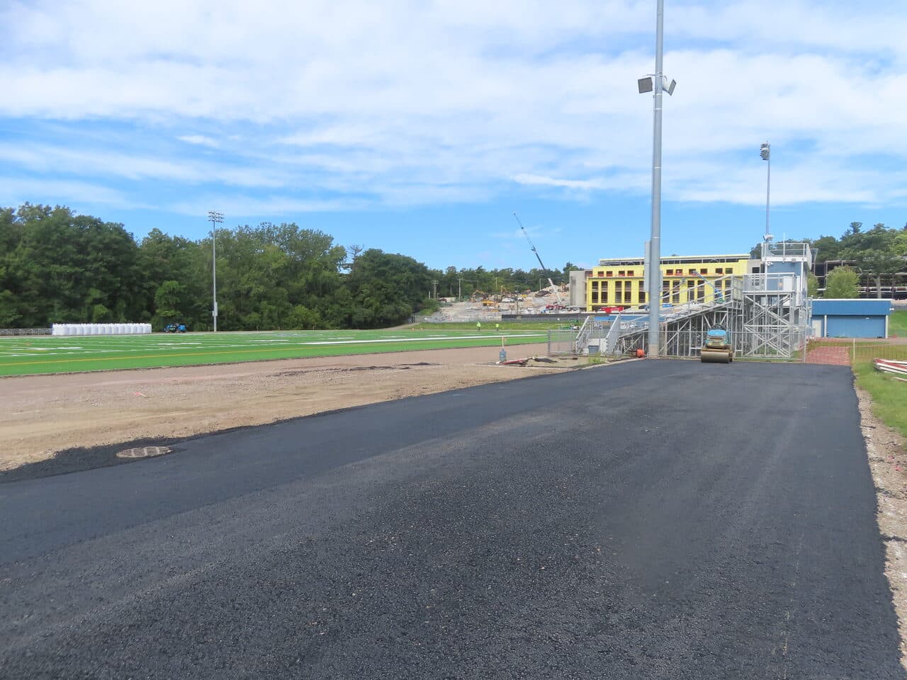 Athletic Surface Base Paving project in Burlington, VT — finished track lane beside turf field