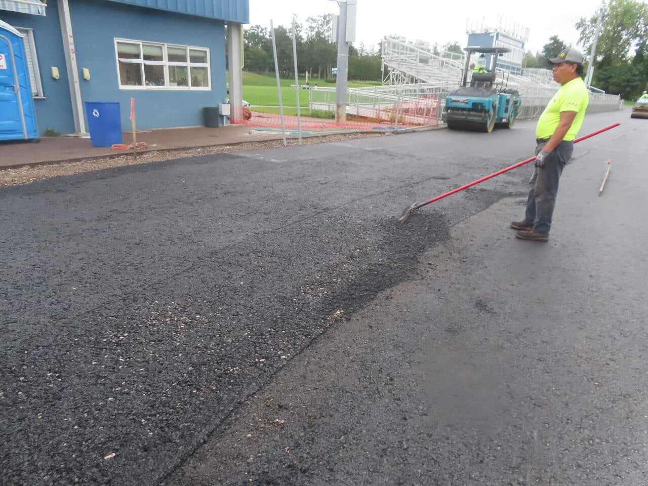 Athletic Surface Base Paving project in Burlington, VT — fresh asphalt patch by fieldhouse