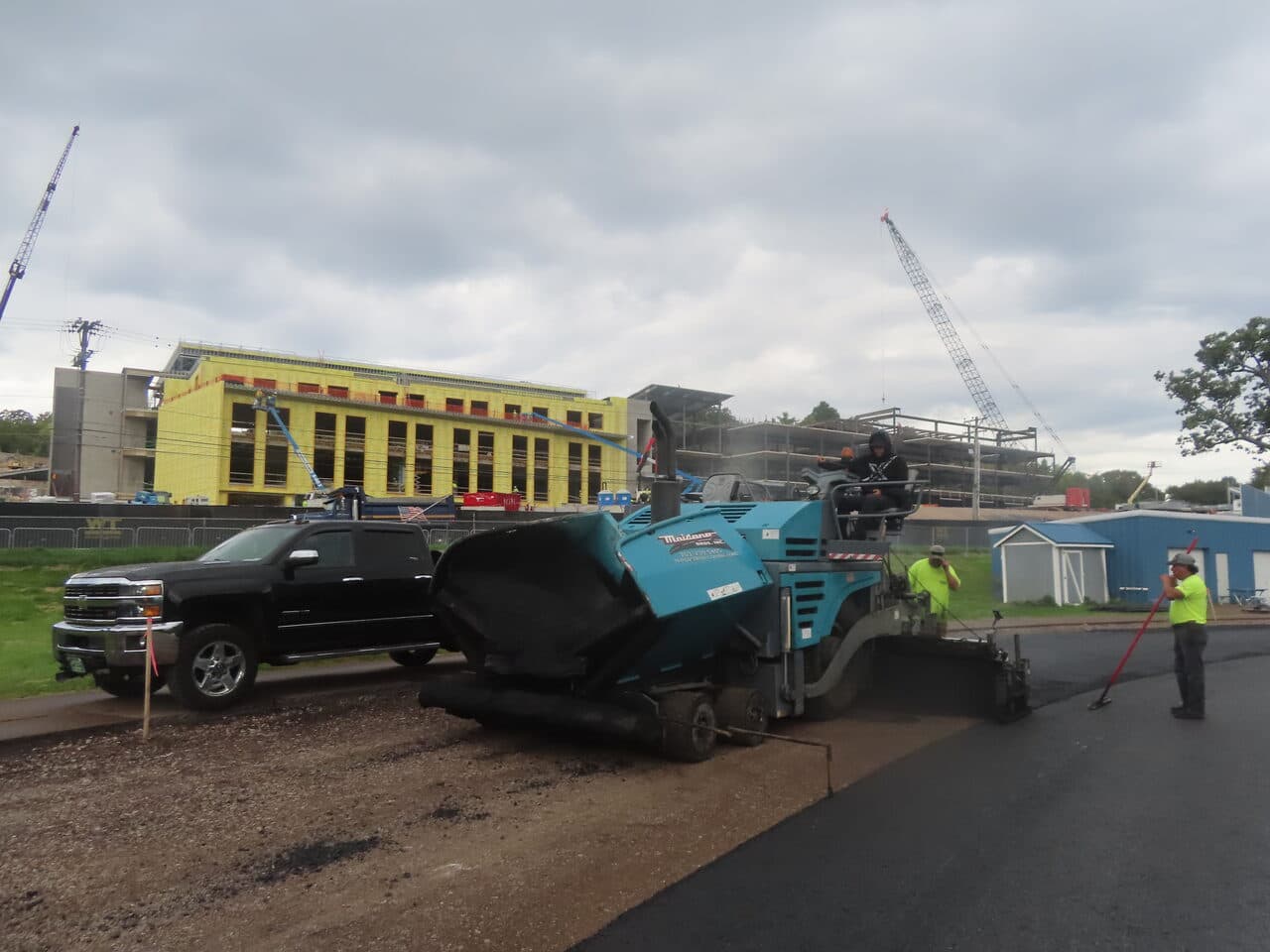 Athletic Surface Base Paving project in Burlington, VT — paver and pickup at construction site