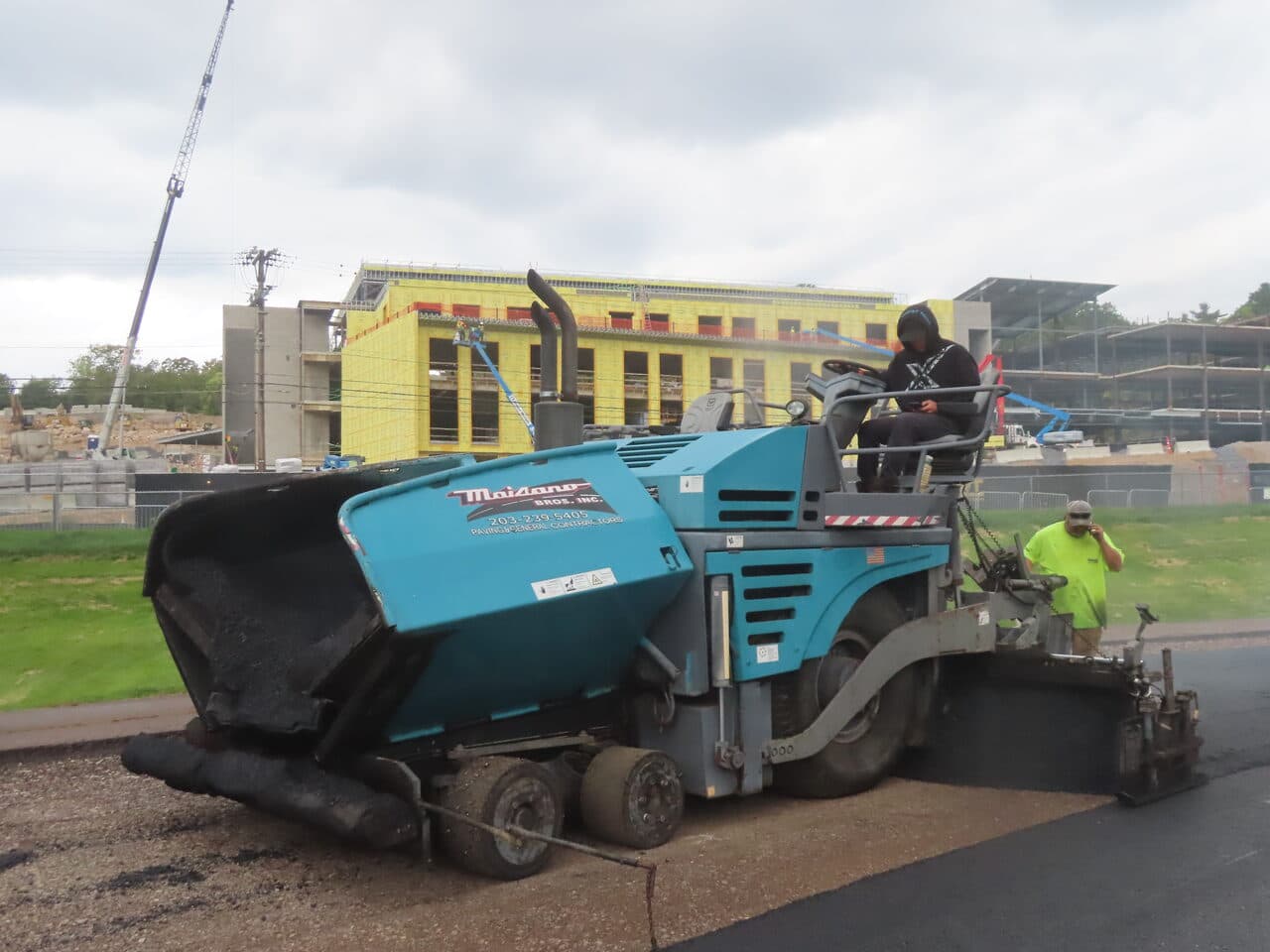 Athletic Surface Base Paving project in Burlington, VT — Maisano paver with school building