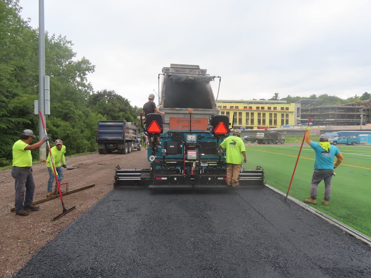 Athletic Surface Base Paving project in Burlington, VT — paver from behind laying mat