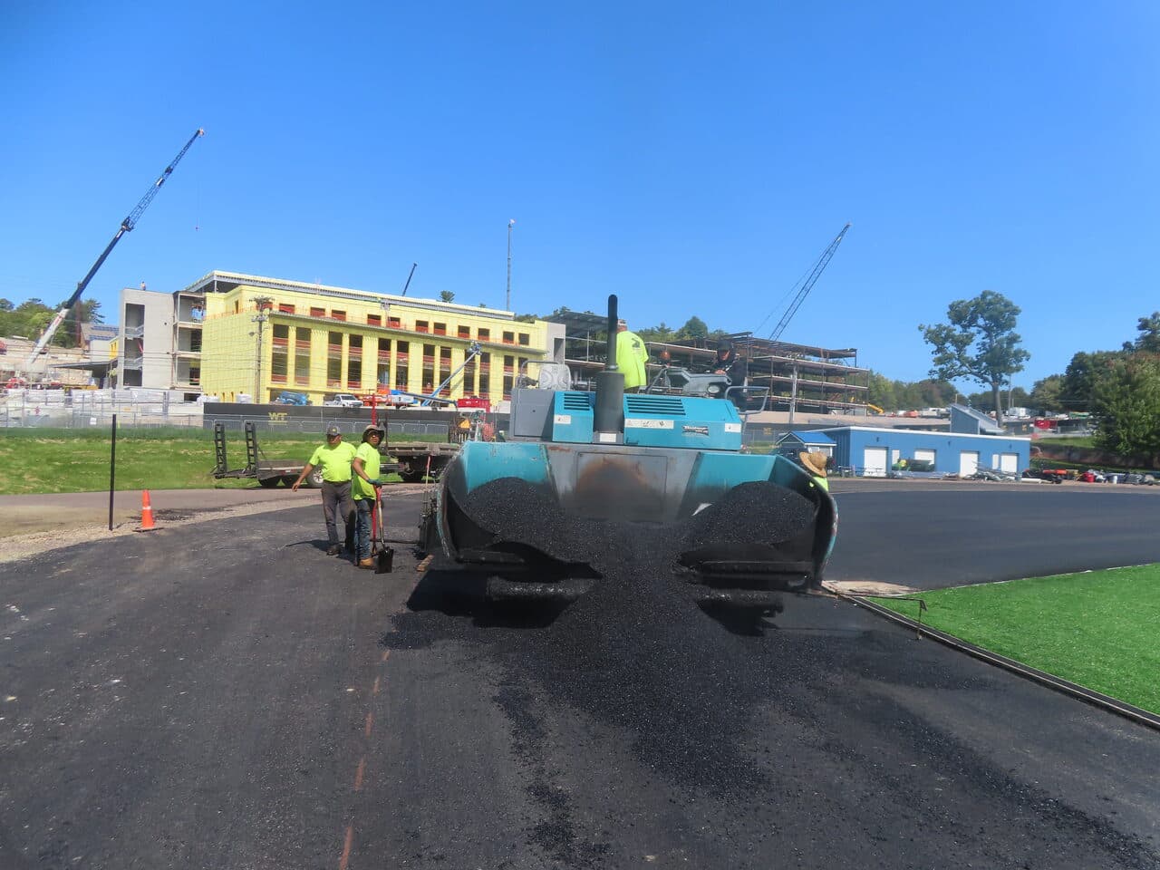 Athletic Surface Base Paving project in Burlington, VT — paver spreading mat sunny day
