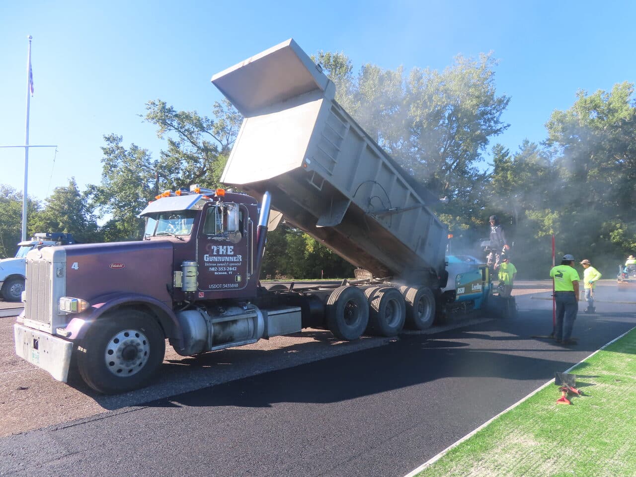 Athletic Surface Base Paving project in Burlington, VT — dump truck feeding paver
