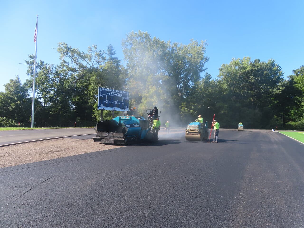 Athletic Surface Base Paving project in Burlington, VT — paving track by scoreboard