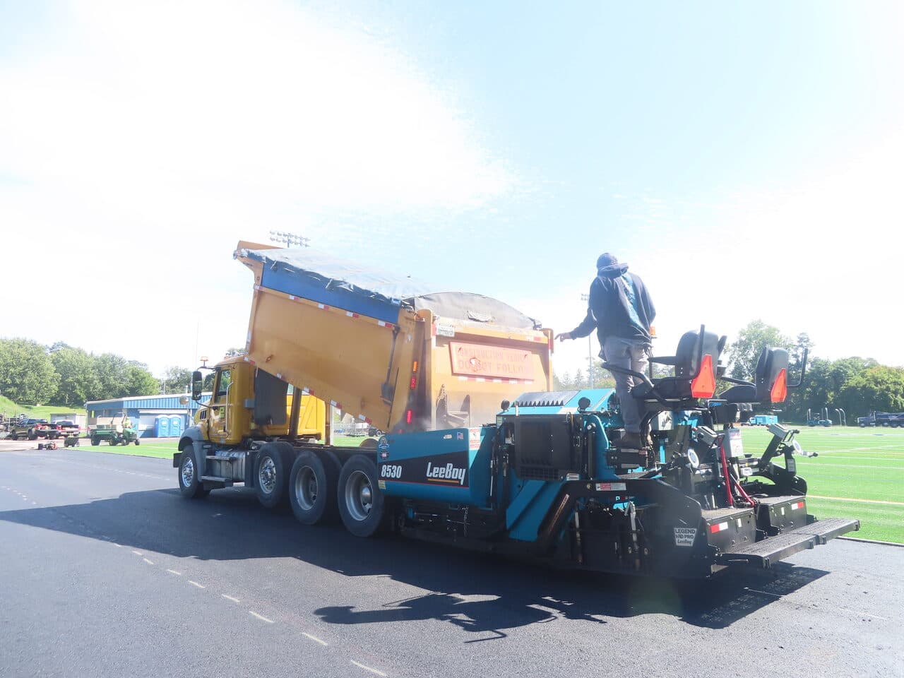 Athletic Surface Base Paving project in Burlington, VT — paver feeding from rear