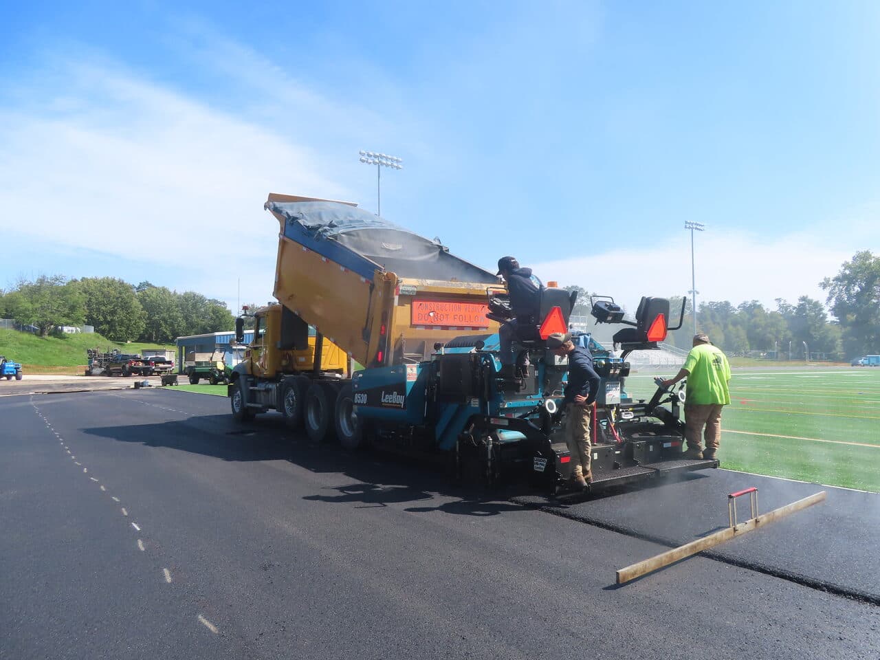Athletic Surface Base Paving project in Burlington, VT — paver beside turf field