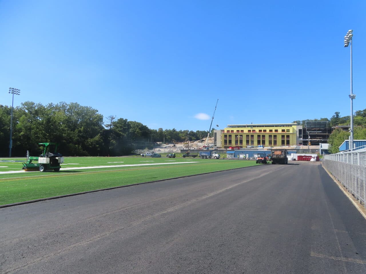 Athletic Surface Base Paving project in Burlington, VT — wide track with field and campus