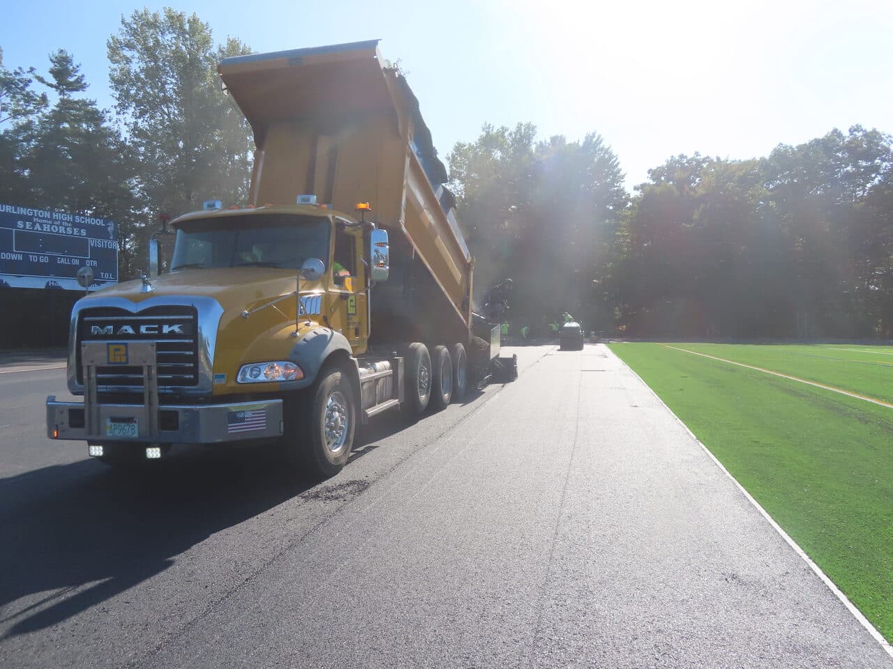 Athletic Surface Base Paving project in Burlington, VT — Mack dump truck on track
