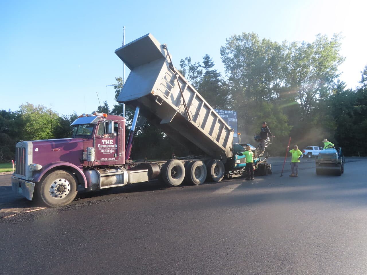 Athletic Surface Base Paving project in Burlington, VT — Gunrunner dump truck feeding paver