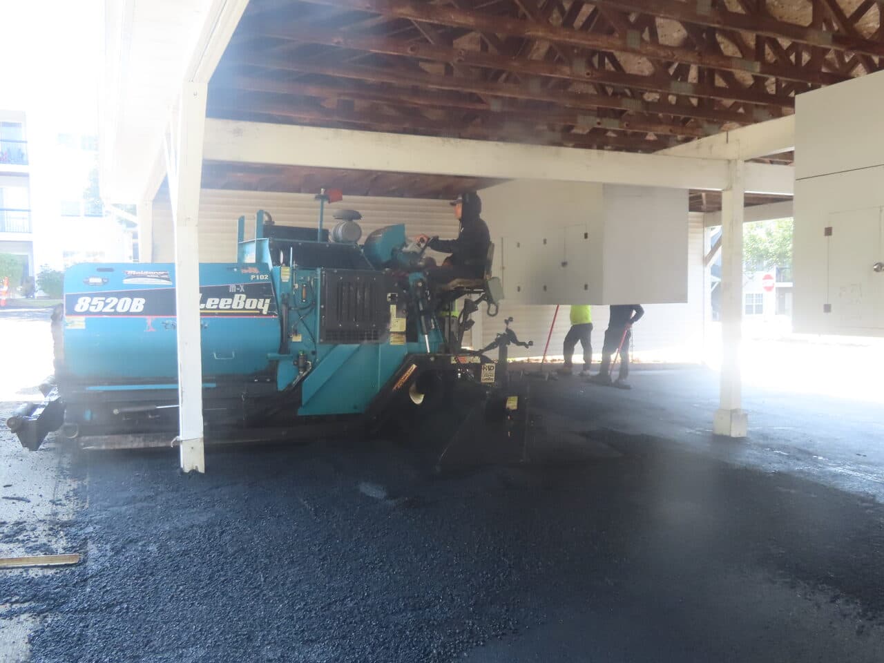 HOA Parking Lot Paving project in Hamden, CT — LeeBoy paver under carport