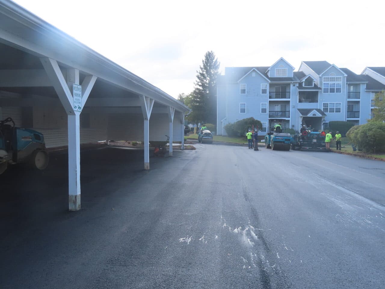 HOA Parking Lot Paving project in Hamden, CT — freshly paved drive by carports