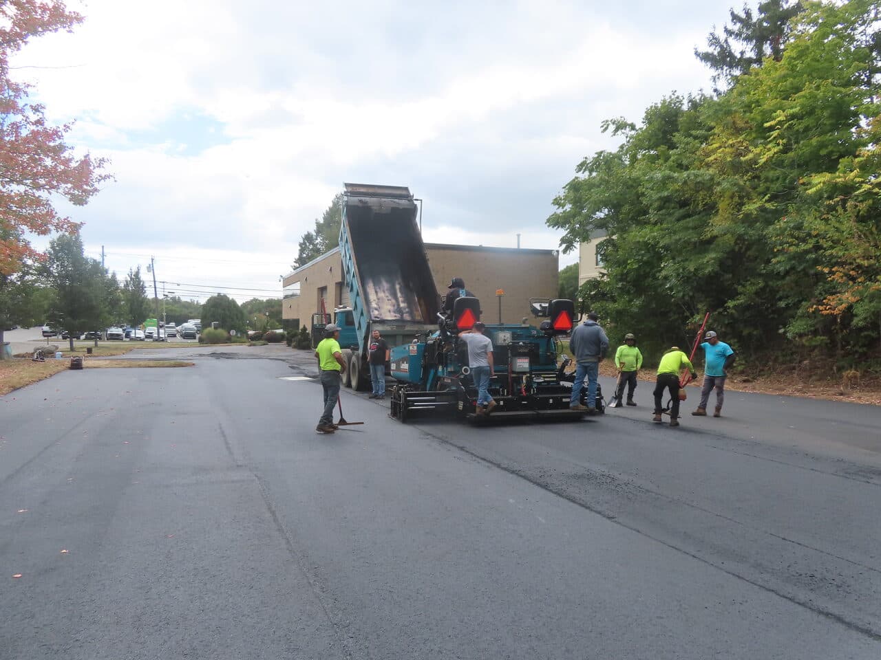 Commercial Parking Lot Paving project in Branford, CT — crew paving commercial lot with paver