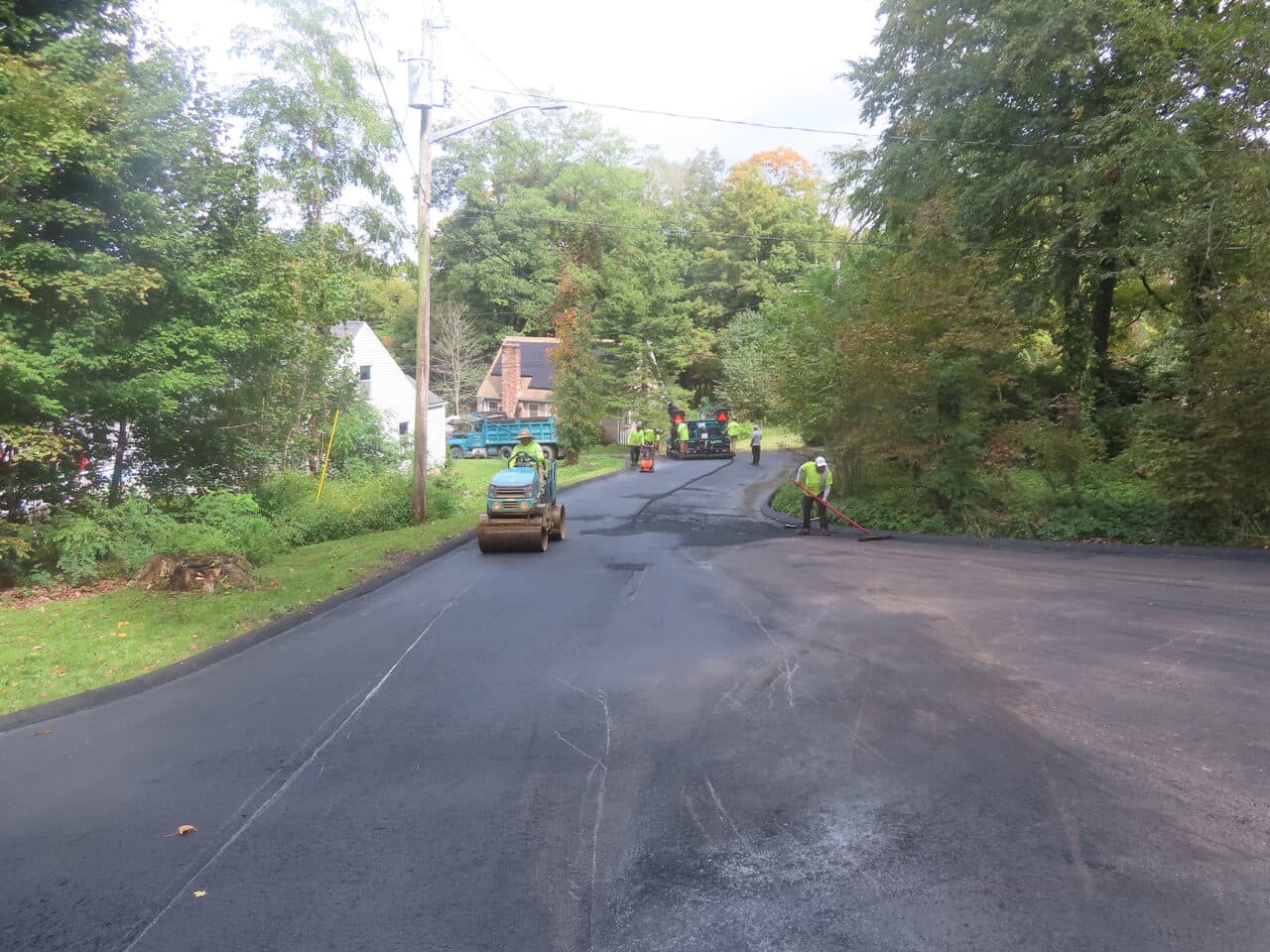 Commercial Parking Lot Paving project in North Branford, CT — new paved road with roller crew