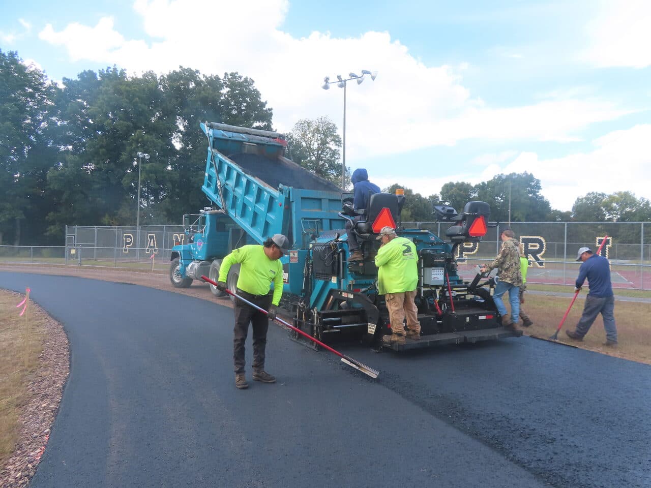 Athletic Surface Base Paving project in East Windsor, CT — paver laying track curve