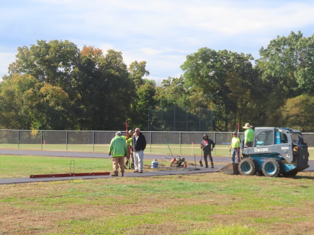 Athletic Surface Base Paving project in East Windsor, CT — crew prepping track base