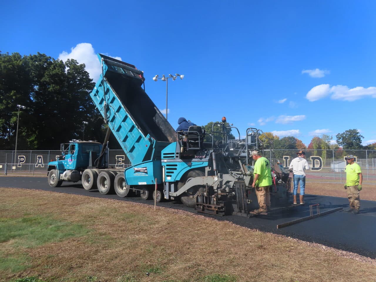 Athletic Surface Base Paving project in East Windsor, CT — dump truck feeding paver