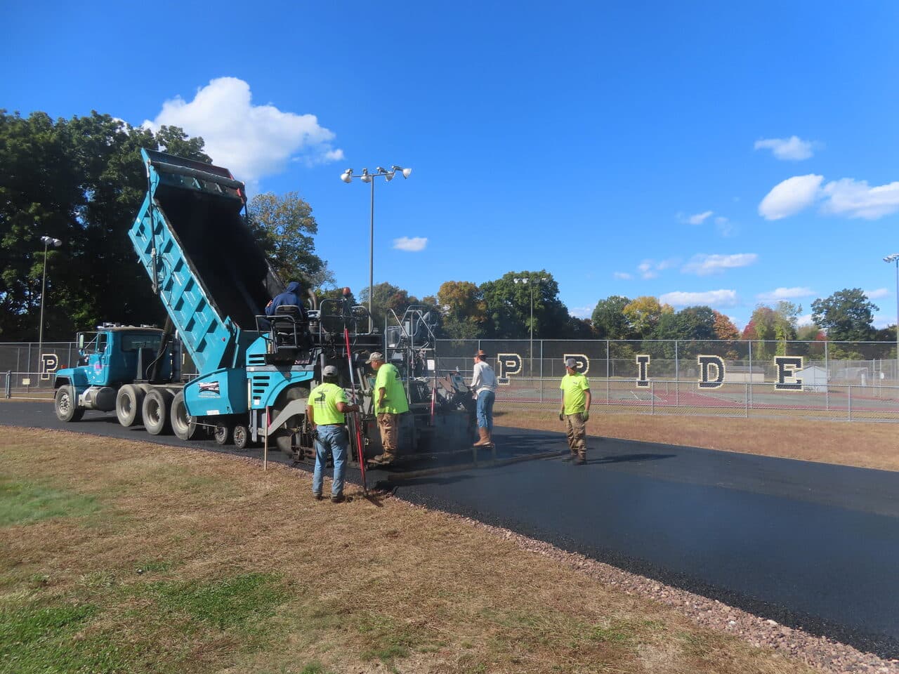 Athletic Surface Base Paving project in East Windsor, CT — fresh asphalt track being paved