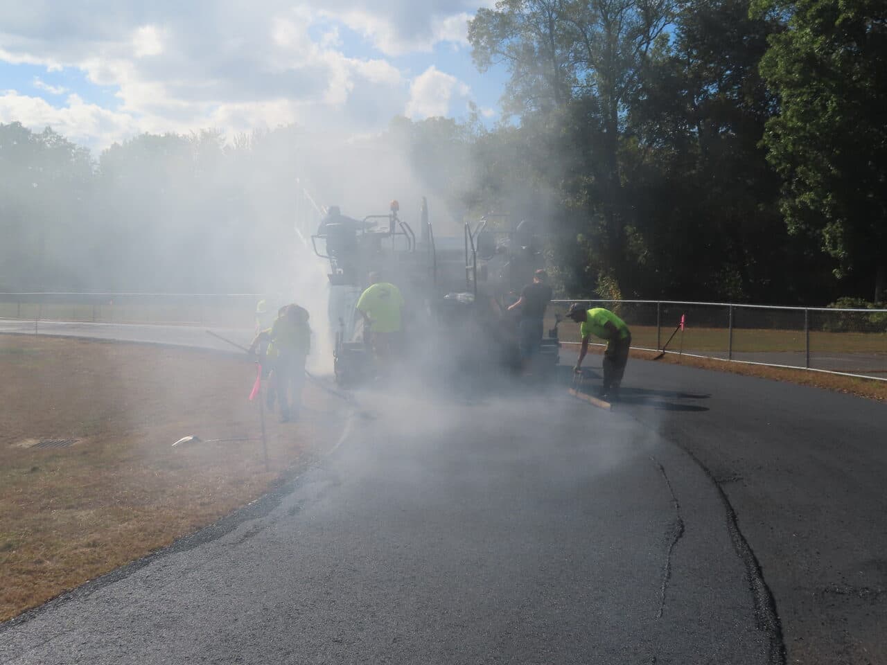 Athletic Surface Base Paving project in East Windsor, CT — paver laying track with steam