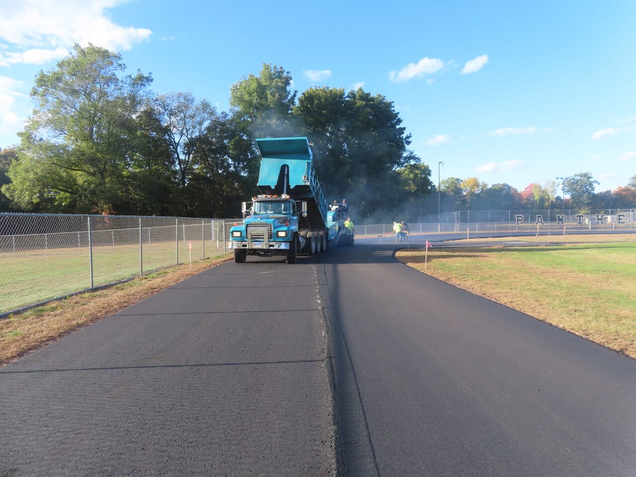 Athletic Surface Base Paving project in East Windsor, CT — finished new asphalt track wide shot