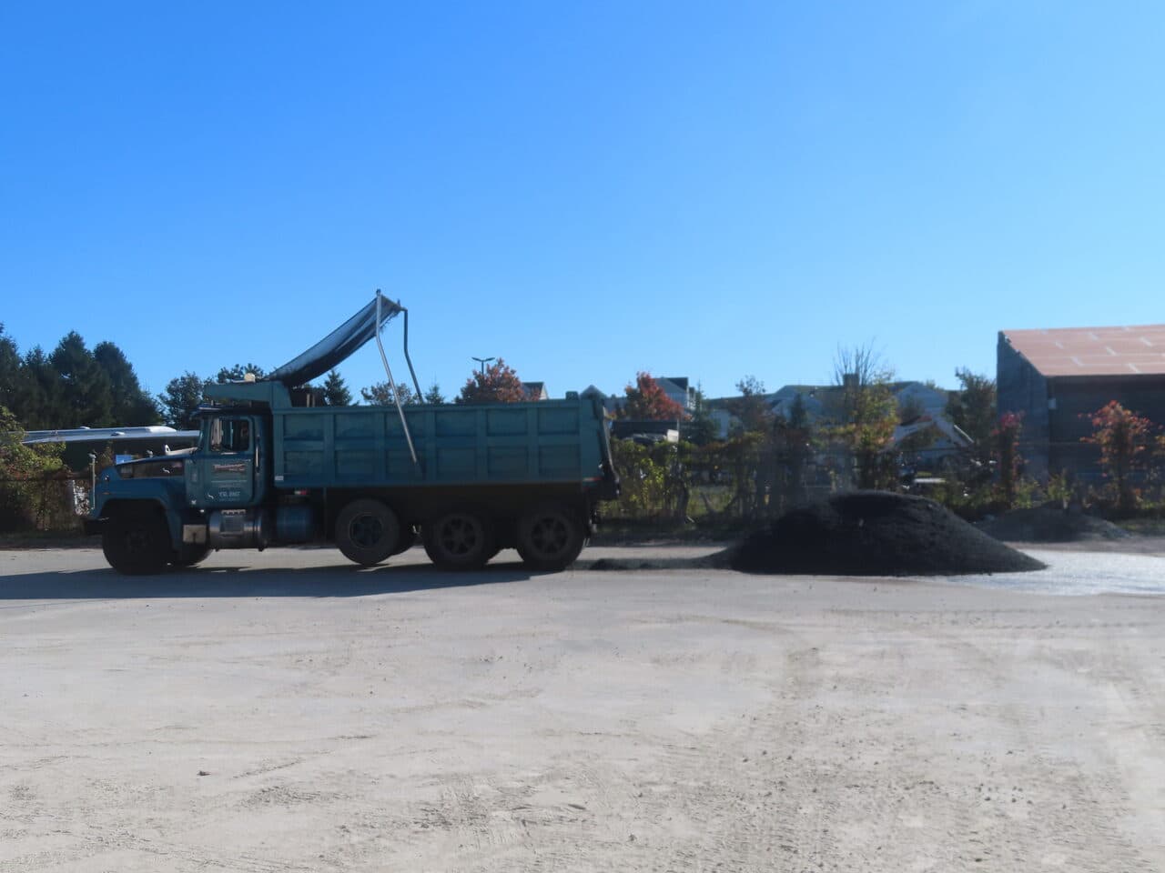 Commercial Parking Lot Paving project in Newport, RI — dump truck and asphalt pile on lot