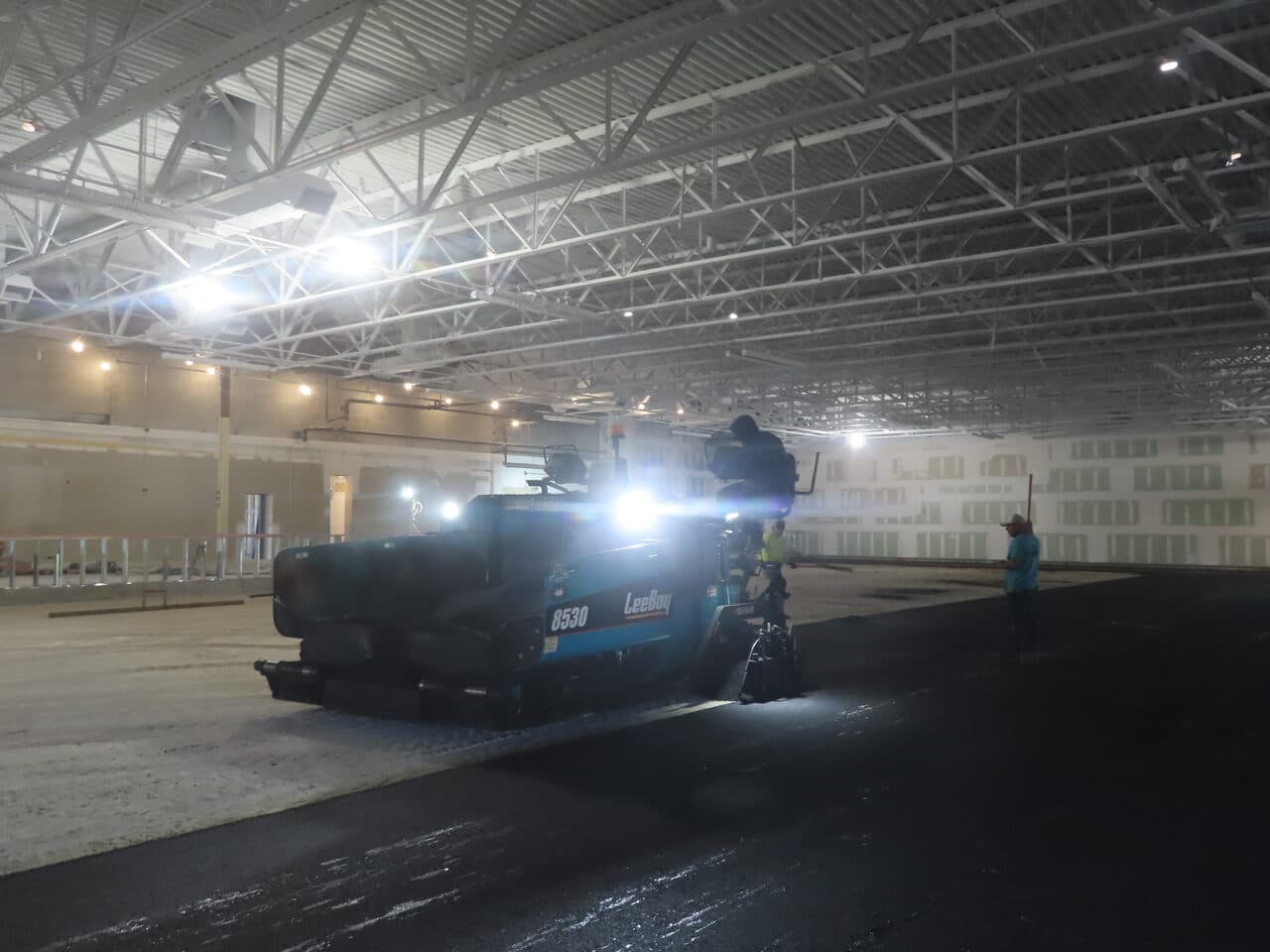 Commercial Parking Lot Paving project in Newport, RI — paver laying asphalt indoors