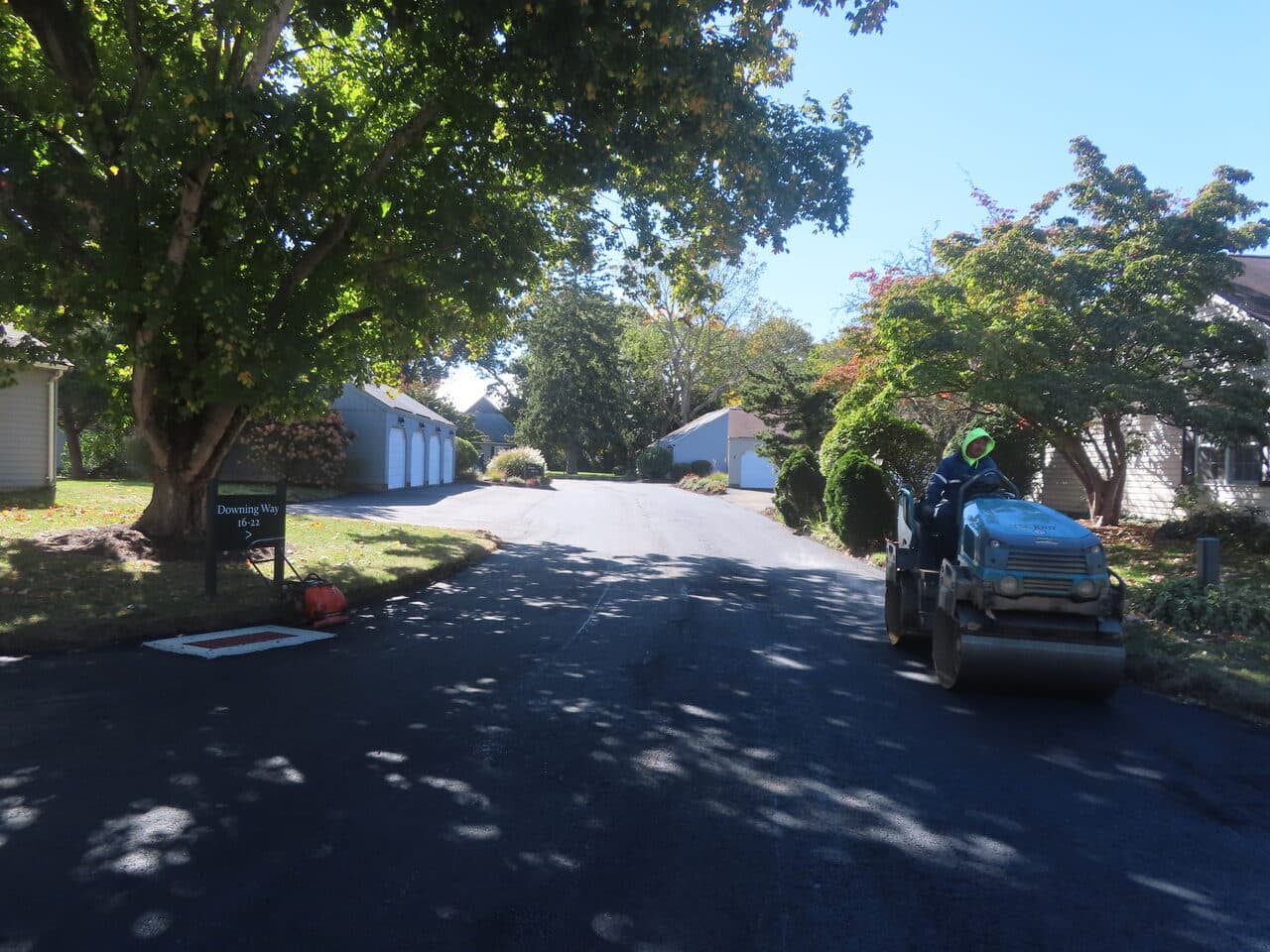 Roadway Paving project in Madison, CT — finished private road with roller