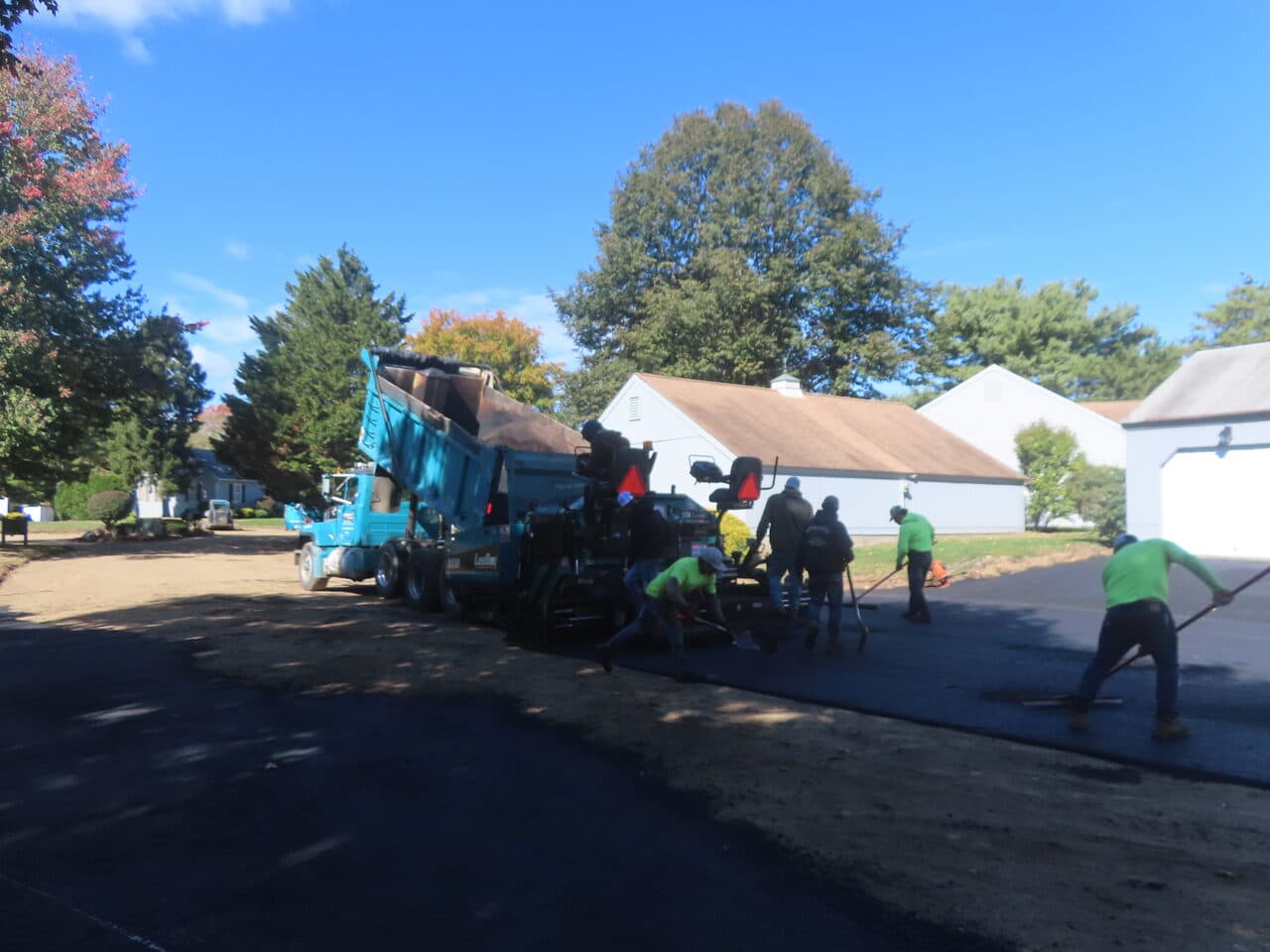 Roadway Paving project in Madison, CT — dump truck feeding paver