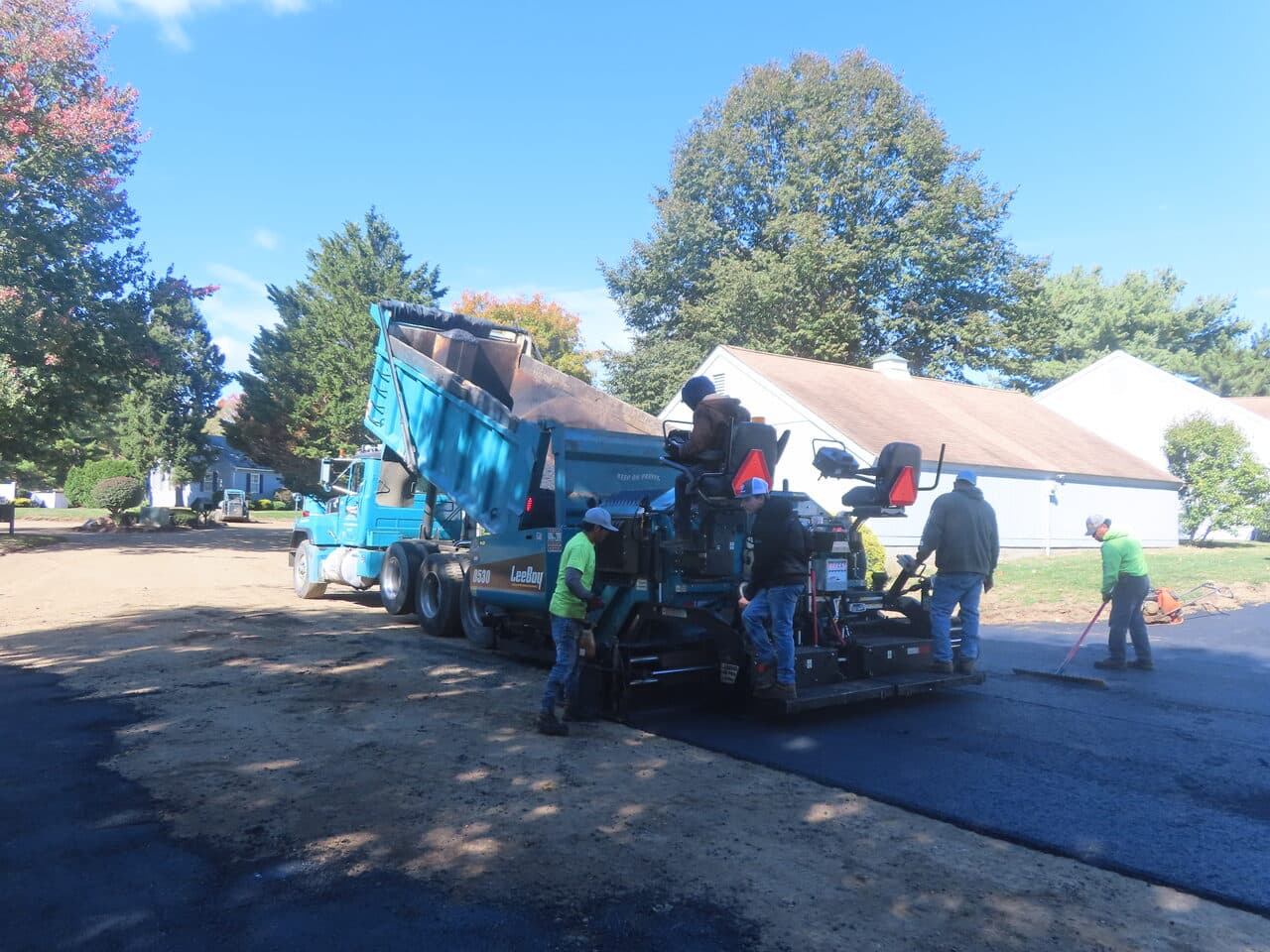 Roadway Paving project in Madison, CT — paving train with truck and crew