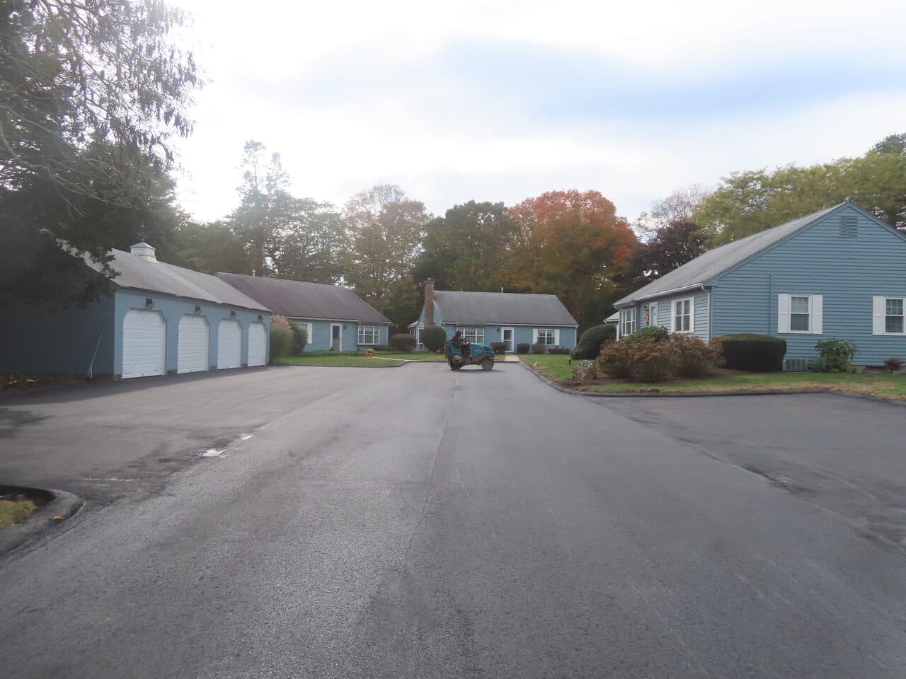 Roadway Paving project in Madison, CT — finished paved road by garages