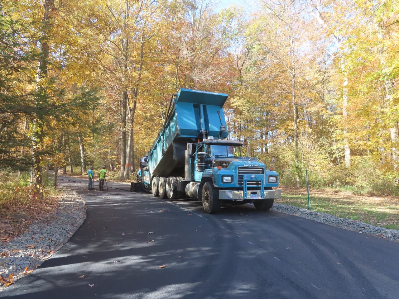 Roadway Paving project in Wallingford, CT — blue dump truck on finished road