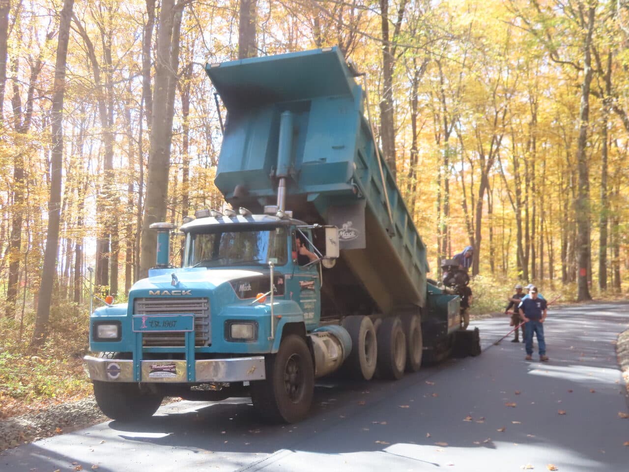 Roadway Paving project in Wallingford, CT — blue Mack dump truck on road