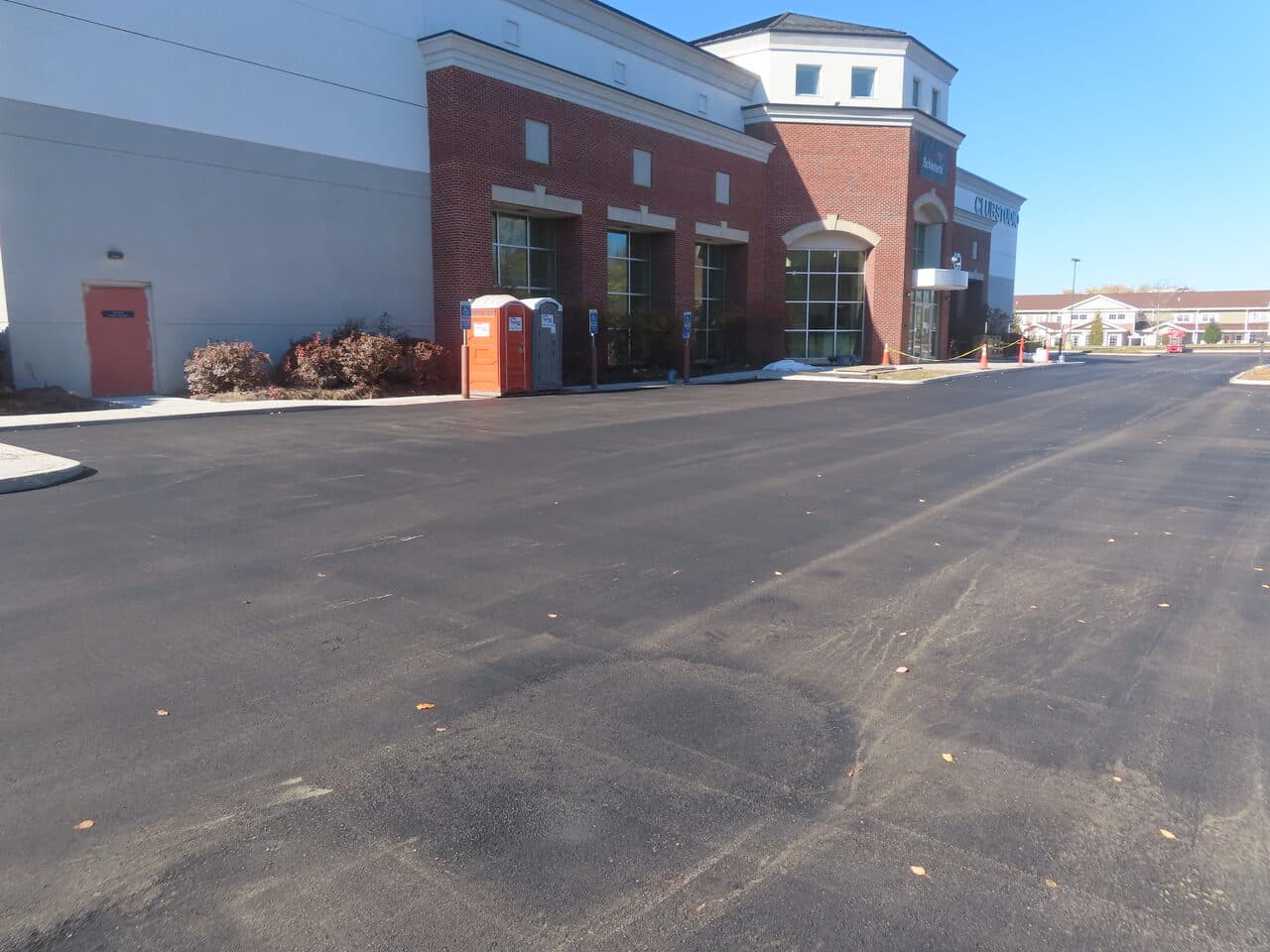 Commercial Parking Lot Paving project in South Windsor, CT — new asphalt lot beside brick building